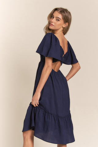 Shop J.NNA Smocked Bow Back Ruffle Hem Dress Now On Klozey Store - Trendy U.S. Premium Women Apparel & Accessories And Be Up-To-Fashion!